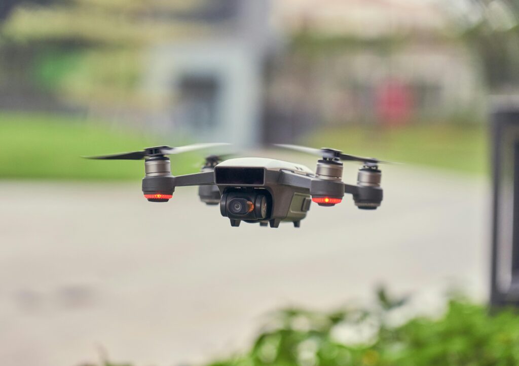 A sleek quadcopter drone captured mid-flight outdoors, showcasing modern technology.
